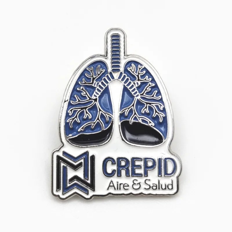 Pin de esmalte suave troquelado en forma de pulmones, en azul y plateado, con un pequeño logotipo debajo.
